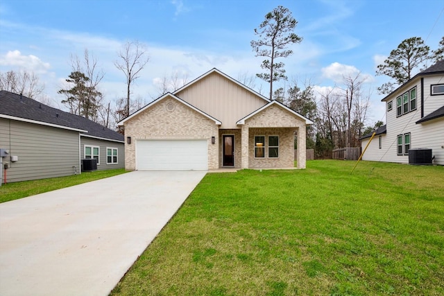 view of front facade with a garage, a front yard, and central air condition unit