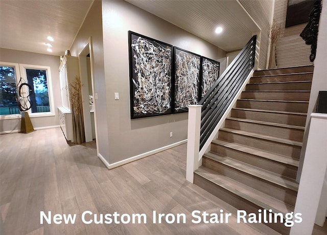 staircase featuring recessed lighting, baseboards, and wood finished floors