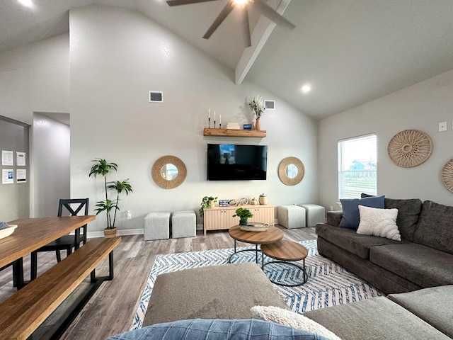 living room featuring hardwood / wood-style flooring, ceiling fan, high vaulted ceiling, and beamed ceiling