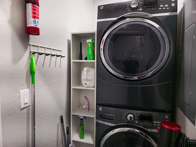 clothes washing area featuring stacked washer and dryer