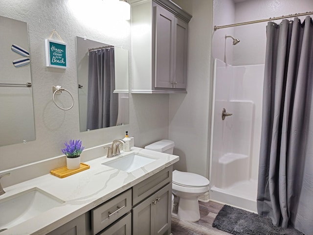 bathroom with a shower with curtain, vanity, toilet, and hardwood / wood-style floors