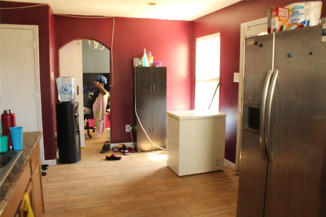 kitchen featuring fridge, stainless steel fridge, and light hardwood / wood-style floors