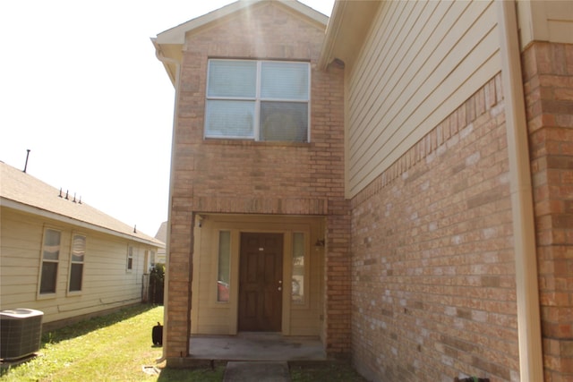 view of exterior entry featuring central AC unit