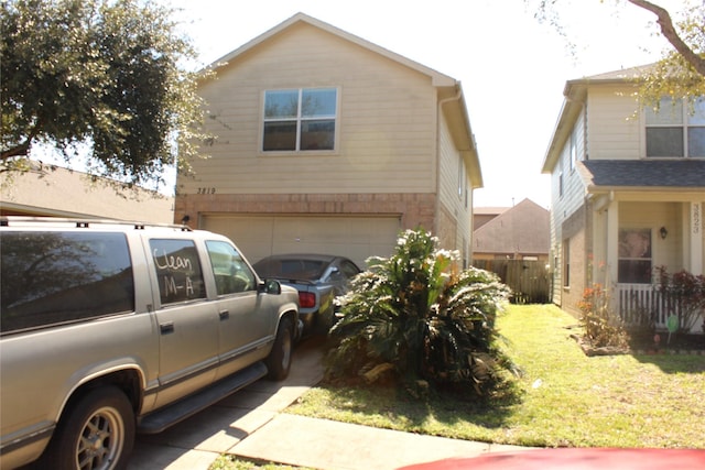 view of side of home featuring a garage and a yard