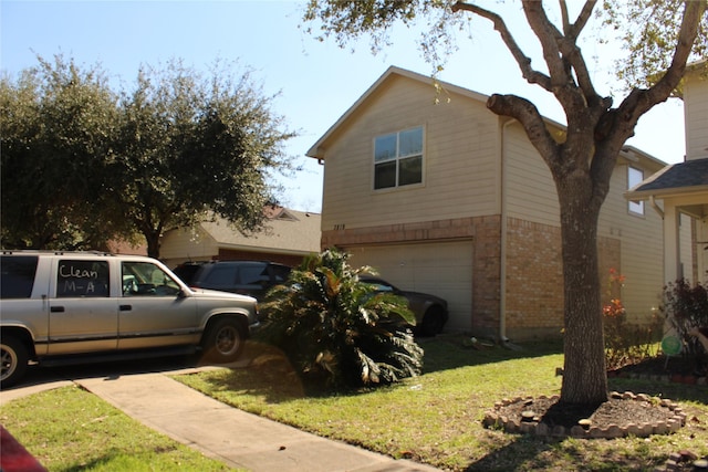 view of side of home featuring a yard and a garage