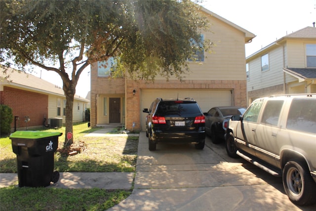 view of front of home featuring cooling unit and a garage