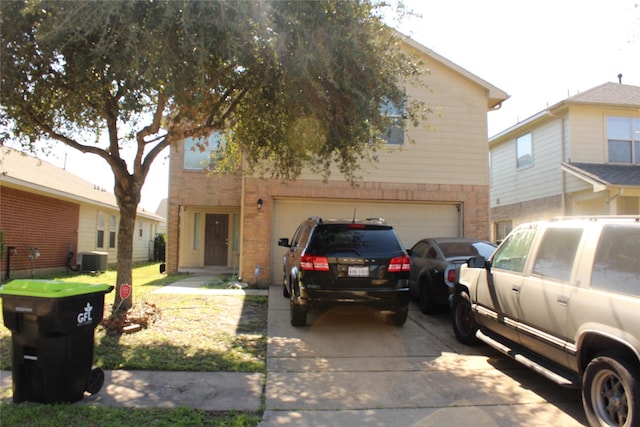 view of front facade with a garage and central AC unit