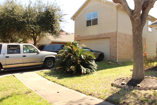 view of side of home featuring a garage and a lawn