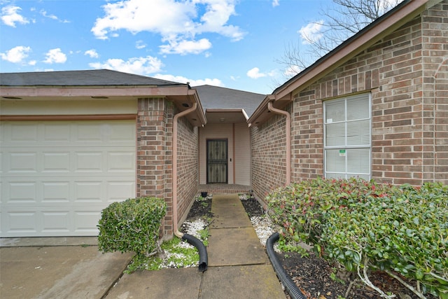 view of exterior entry with a garage