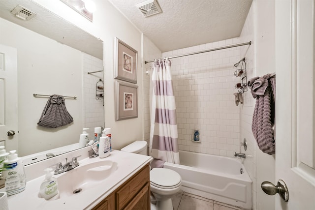 full bathroom with tile patterned flooring, vanity, toilet, a textured ceiling, and shower / bath combo with shower curtain