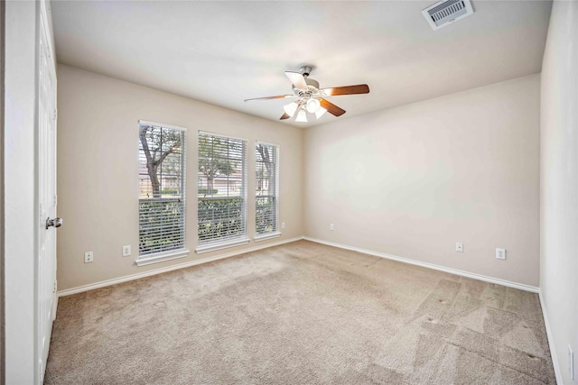 carpeted empty room featuring ceiling fan