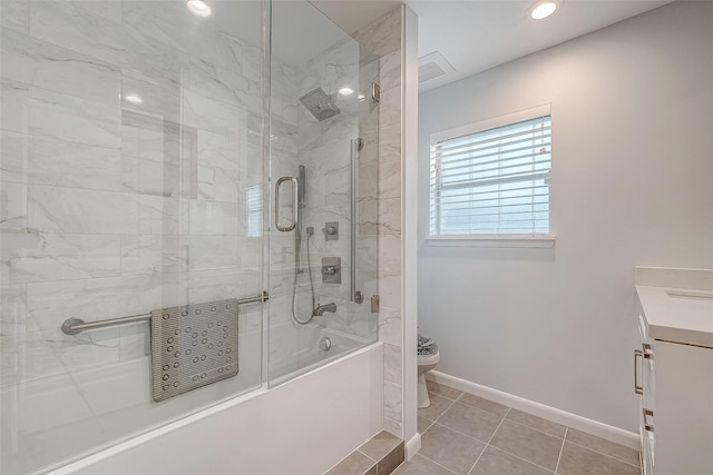 full bathroom with bath / shower combo with glass door, tile patterned floors, toilet, and vanity