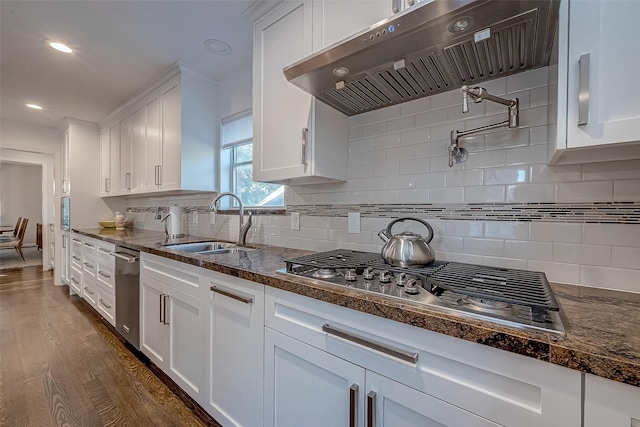 kitchen with white cabinetry, stainless steel gas cooktop, sink, and extractor fan