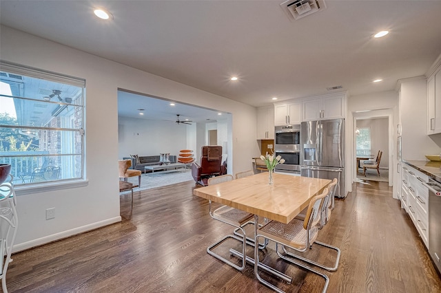 dining room with dark hardwood / wood-style floors and ceiling fan