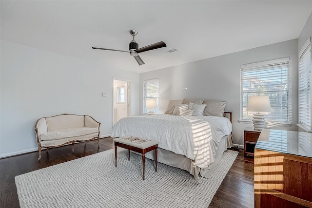 bedroom with multiple windows, ceiling fan, and dark hardwood / wood-style flooring