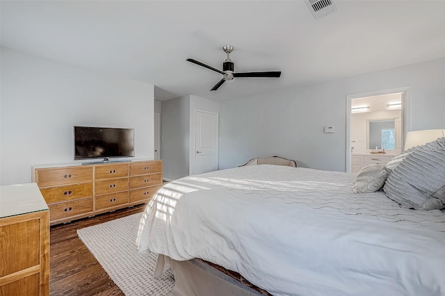 bedroom with dark hardwood / wood-style floors, connected bathroom, and ceiling fan