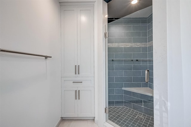 bathroom with a shower with door