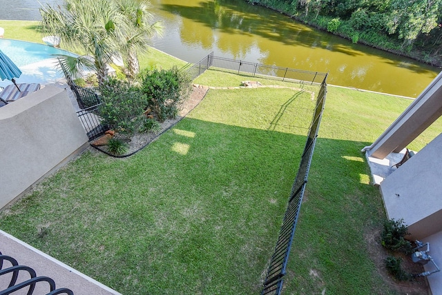 view of yard with a fenced in pool, fence private yard, and a water view