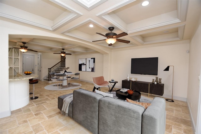 living room featuring stone tile floors, stairway, coffered ceiling, and beamed ceiling