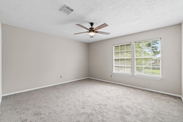 unfurnished room featuring baseboards, visible vents, carpet flooring, and ceiling fan