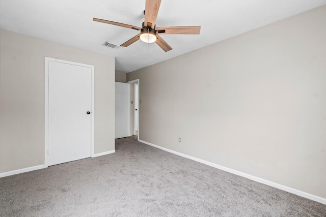 unfurnished bedroom with visible vents, carpet flooring, baseboards, and ceiling fan