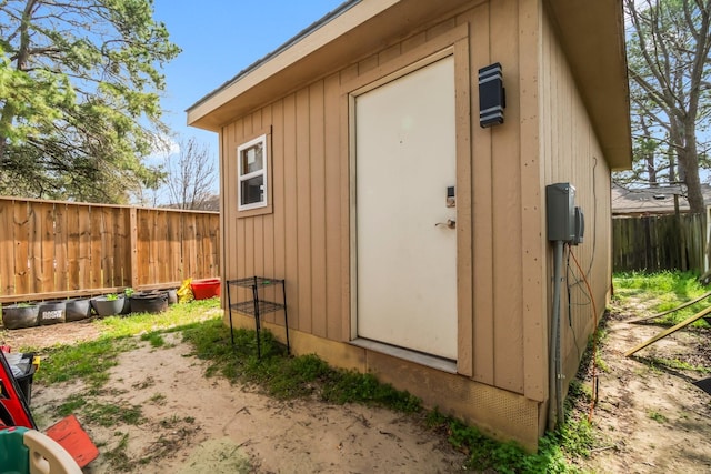view of shed featuring fence