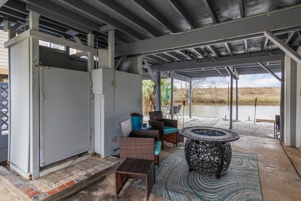 view of patio / terrace featuring a water view and an outdoor fire pit