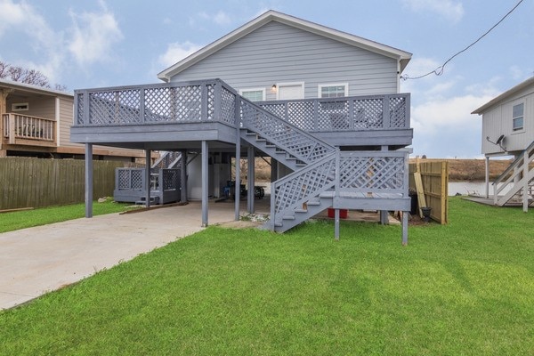 rear view of house with a carport and a yard