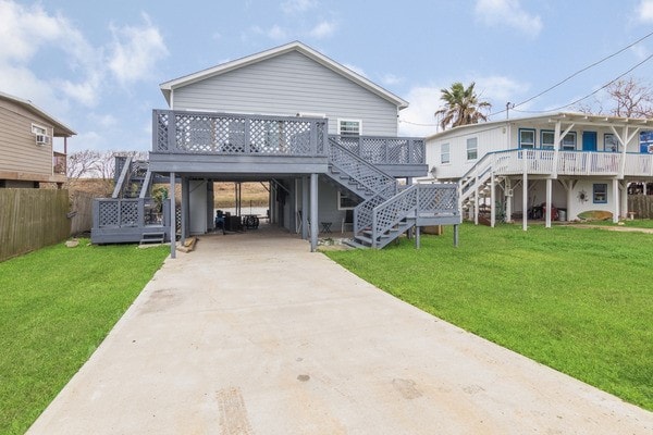 rear view of house featuring a yard and a carport