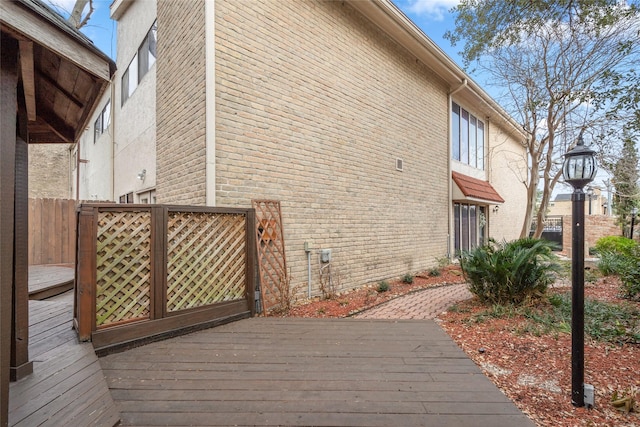 view of home's exterior with a wooden deck