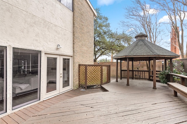 wooden terrace featuring a gazebo and french doors