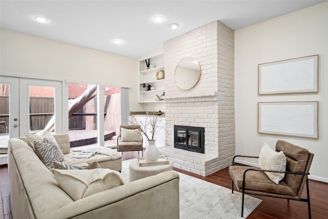 living room featuring french doors, a fireplace, and dark hardwood / wood-style floors