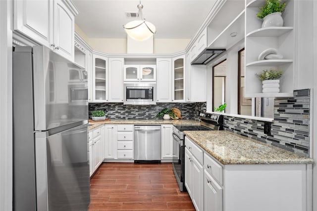 kitchen with tasteful backsplash, dark hardwood / wood-style flooring, stainless steel appliances, light stone countertops, and white cabinets