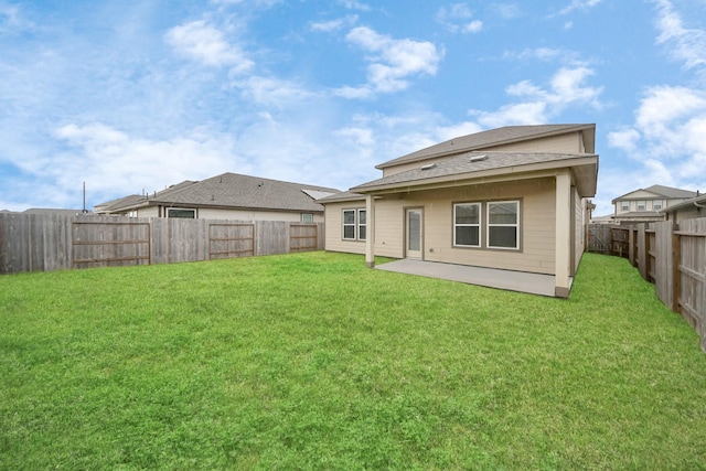 rear view of property featuring a patio and a yard