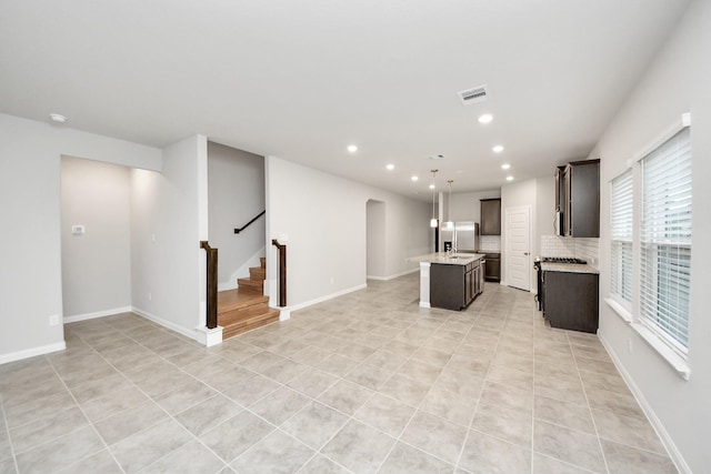 unfurnished living room with light tile patterned flooring