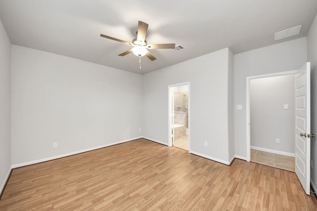 unfurnished bedroom featuring ceiling fan, ensuite bathroom, and light hardwood / wood-style flooring