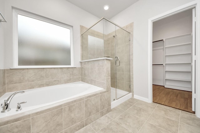 bathroom featuring tile patterned floors and separate shower and tub