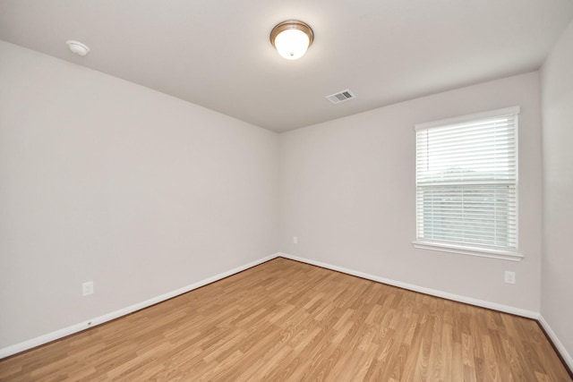 spare room with light hardwood / wood-style flooring