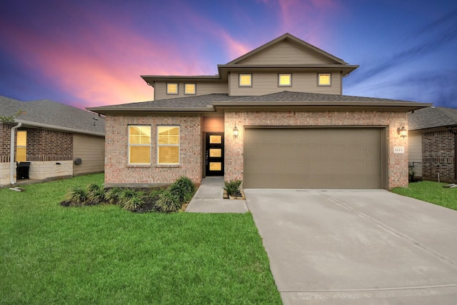 view of front of home featuring a garage and a yard