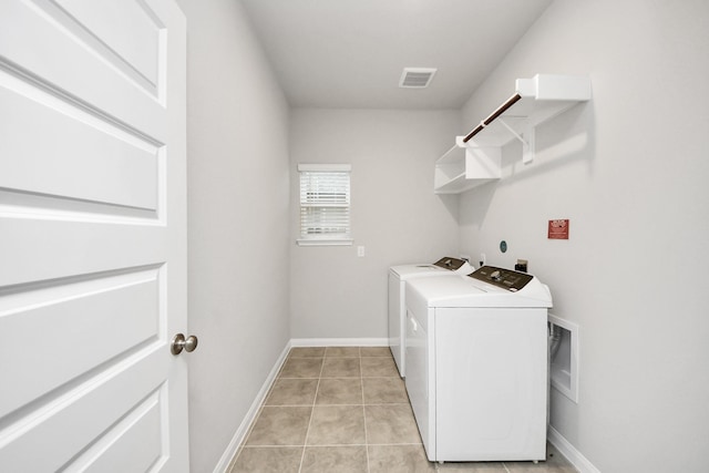 laundry room featuring light tile patterned flooring and washing machine and dryer