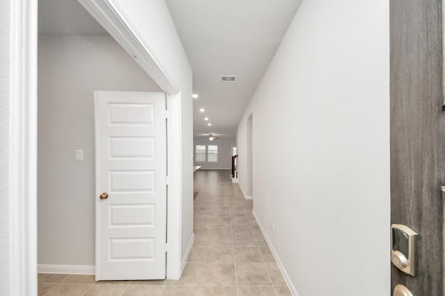 corridor featuring light tile patterned floors