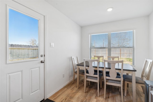 dining space with light wood-style floors, baseboards, and recessed lighting