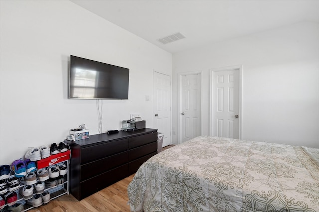 bedroom with visible vents and wood finished floors