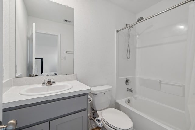 bathroom with visible vents, shower / bath combination, vanity, and toilet