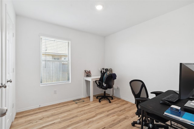 office featuring light wood-type flooring and baseboards