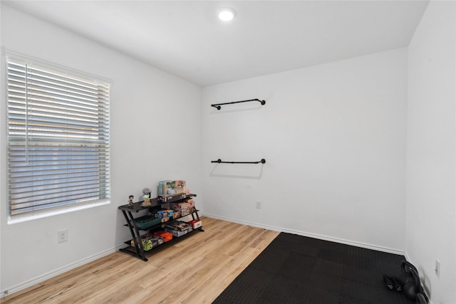 interior space featuring light wood-style flooring and baseboards