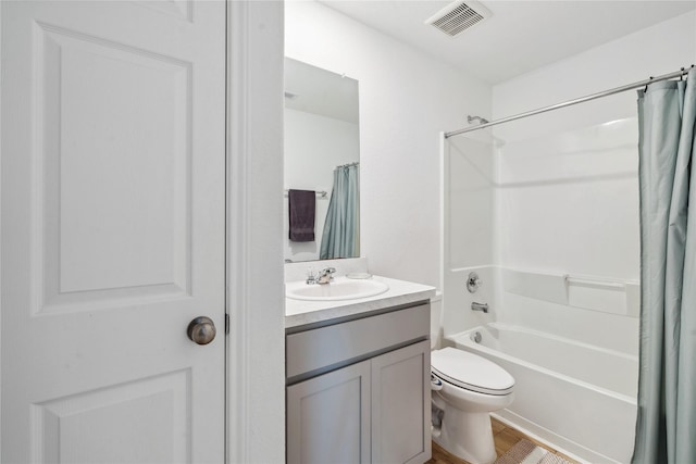 full bath with toilet, wood finished floors, vanity, visible vents, and shower / bathtub combination with curtain