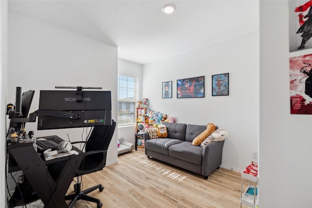 office space with light wood-style floors and baseboards