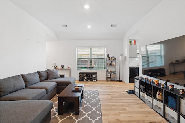 living room featuring lofted ceiling, light wood-style floors, visible vents, and recessed lighting