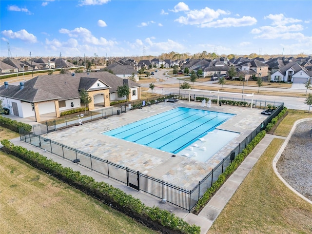 community pool with a residential view and fence